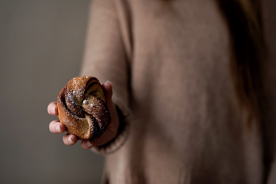 person holding brown and black stone