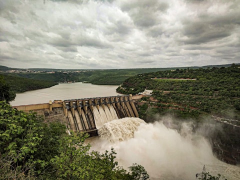 water falls under cloudy sky during daytime