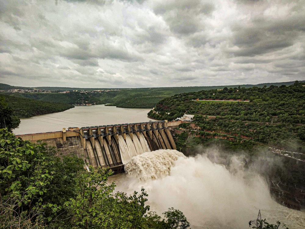 water falls under cloudy sky during daytime