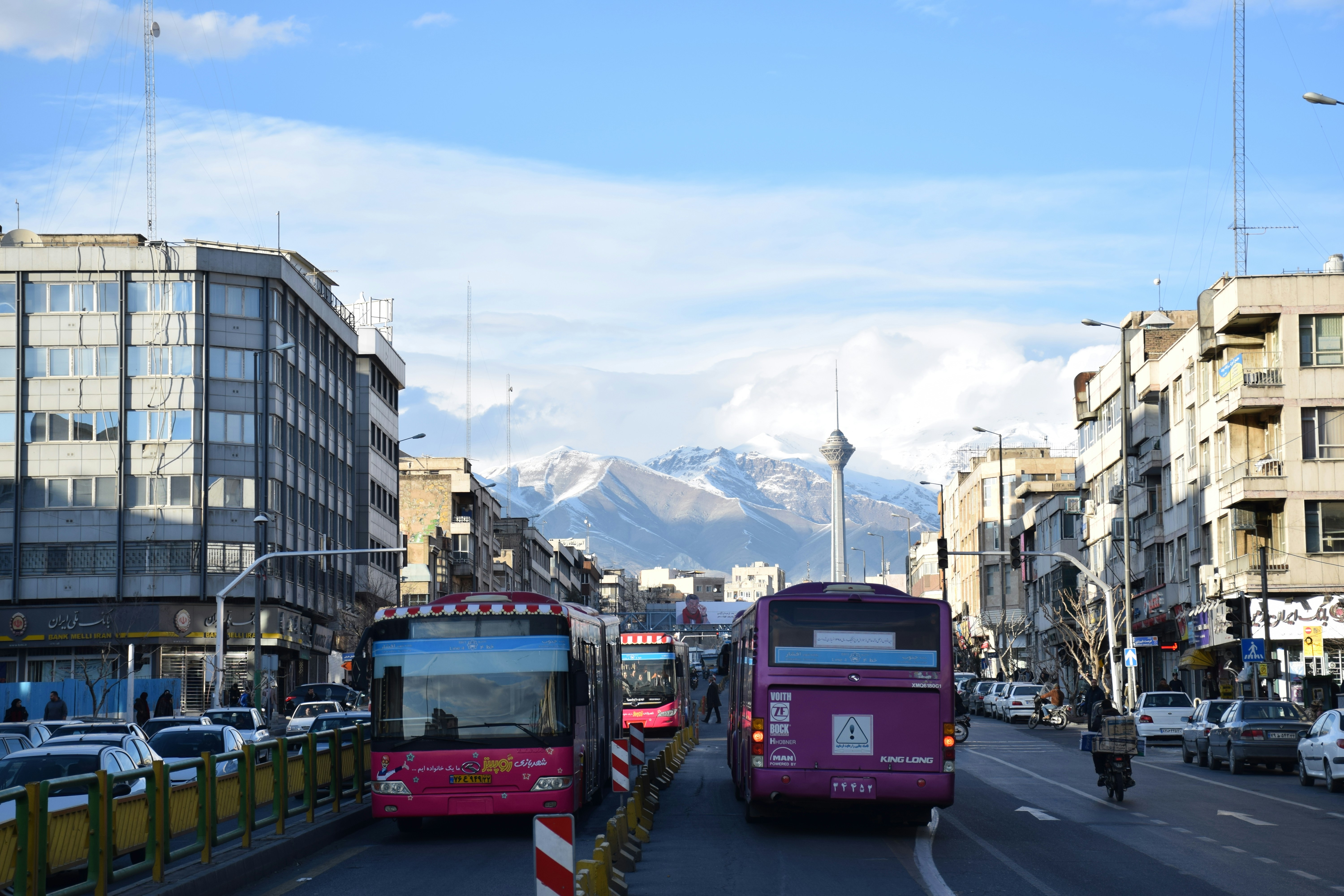 red bus on road during daytime