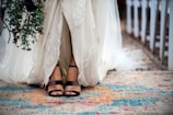 woman in white floral dress and black leather sandals