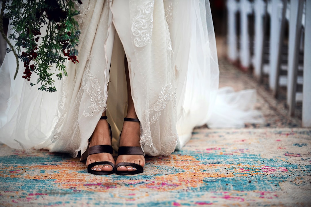 woman in white floral dress and black leather sandals