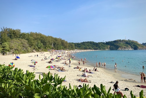 A lively beach scene in Brazil with families enjoying the sun and waves.