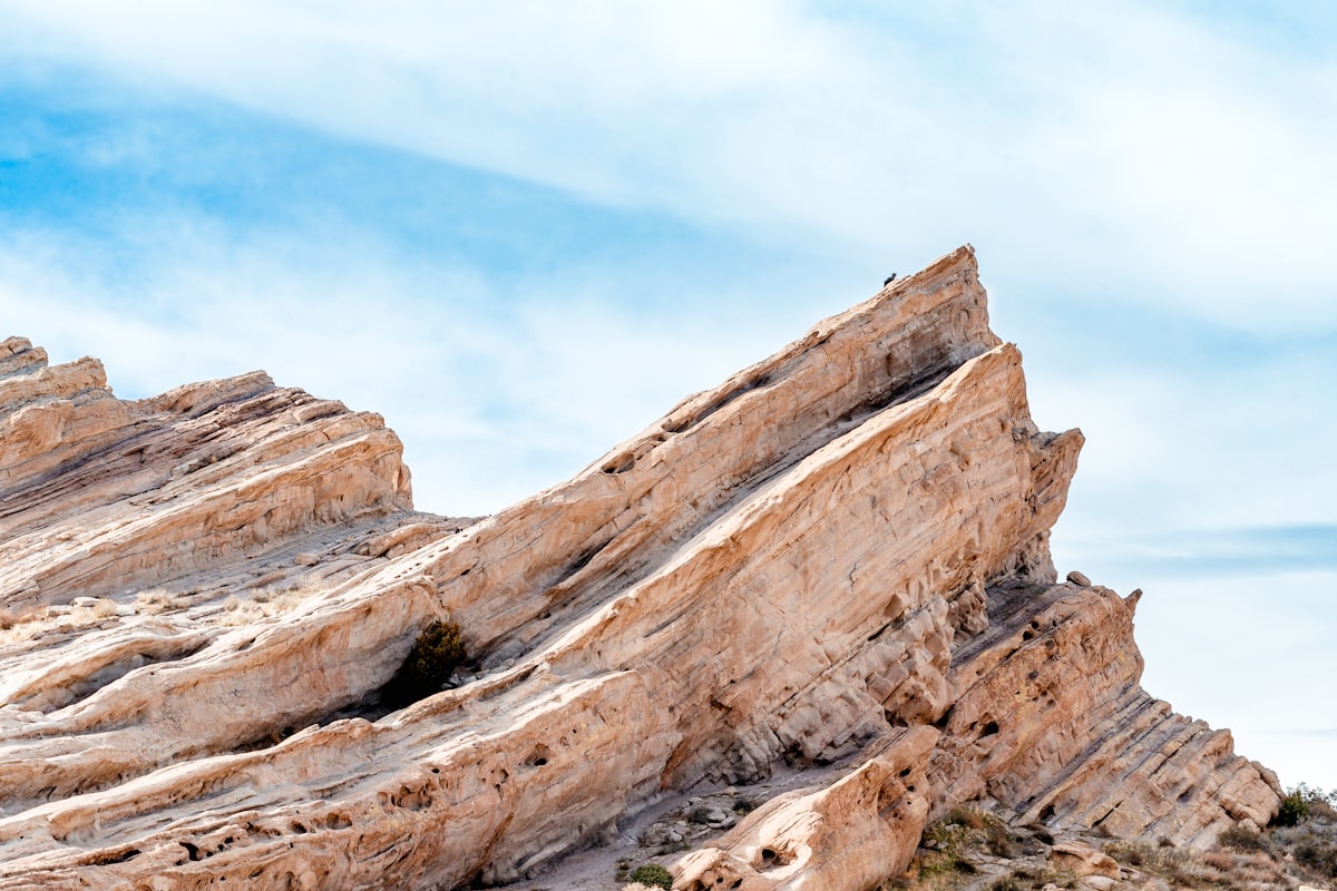 Tilted and folded sedimentary rock strata layers, showing the geological structures that engineering geologists study and characterise
