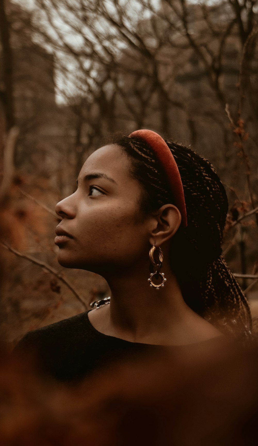 woman in black shirt wearing silver earrings