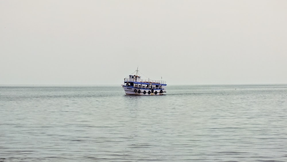 black and white boat on sea during daytime