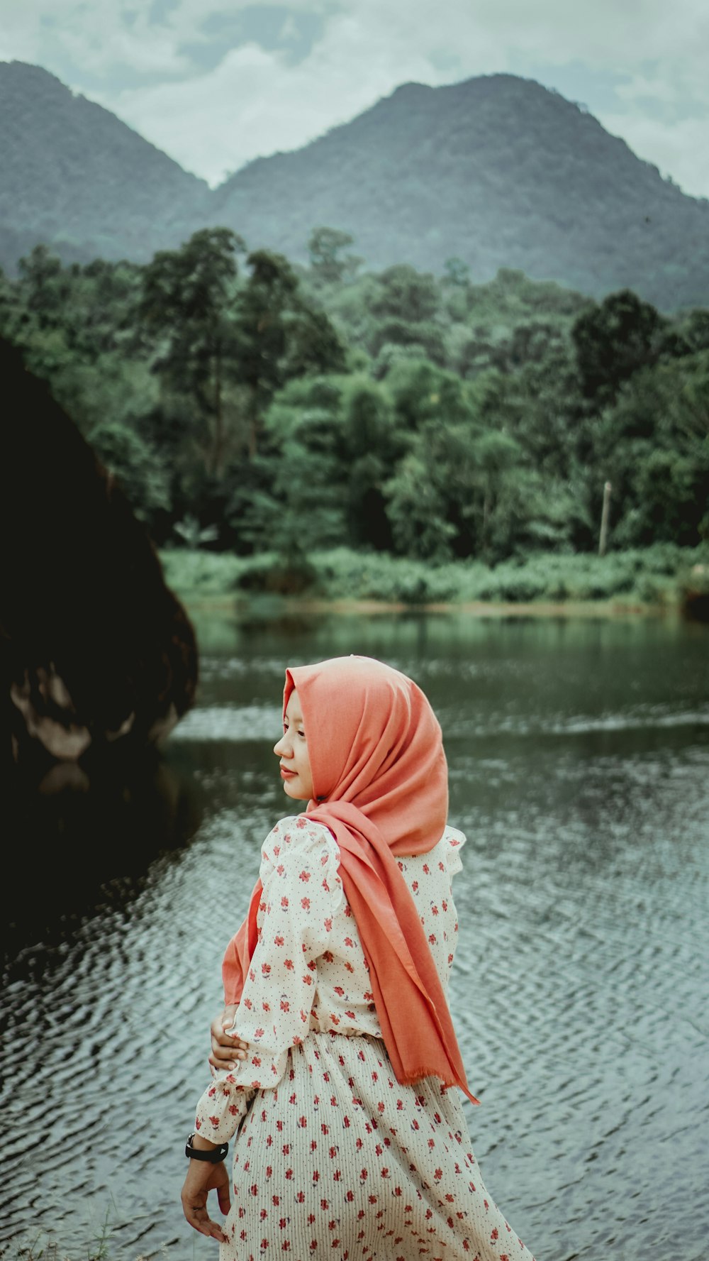 woman in pink hijab near river during daytime