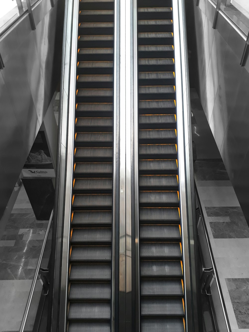 black and brown escalator in a room