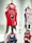 A display of several basketball jerseys hanging on a wall, each on wooden hangers. The prominent jersey is red with the word 'BULLS' and a graphic face logo. Other jerseys include a white New York jersey with blue and red accents and a blue jersey with intricate patterns.