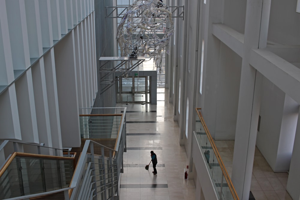 2 people walking on white staircase