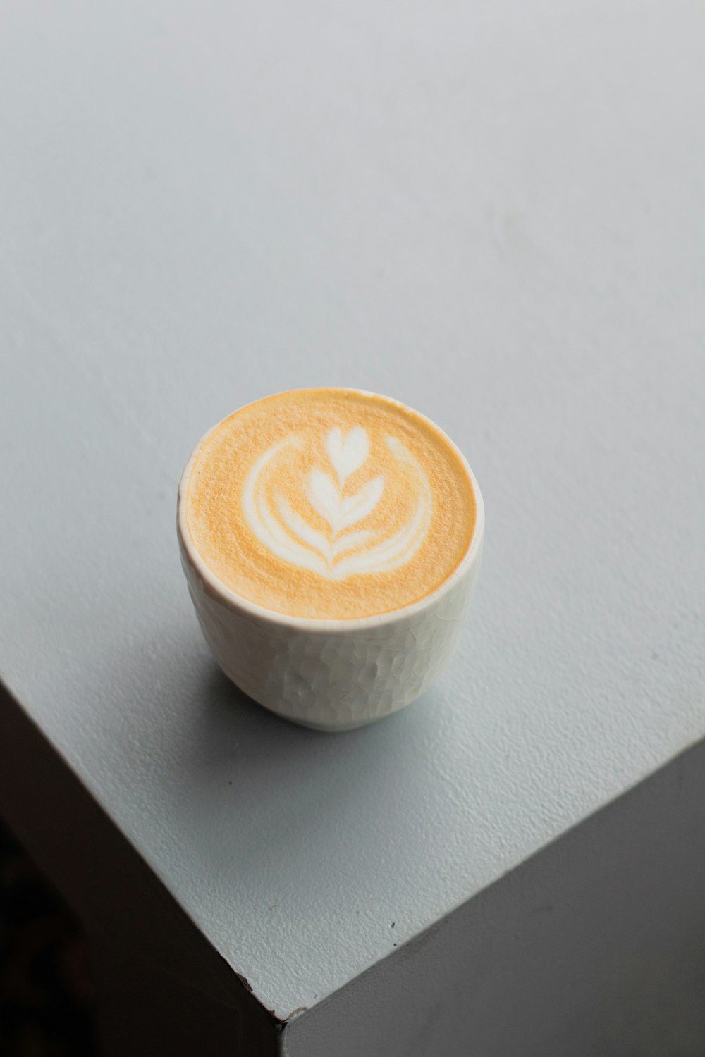 white ceramic cup with brown and white liquid