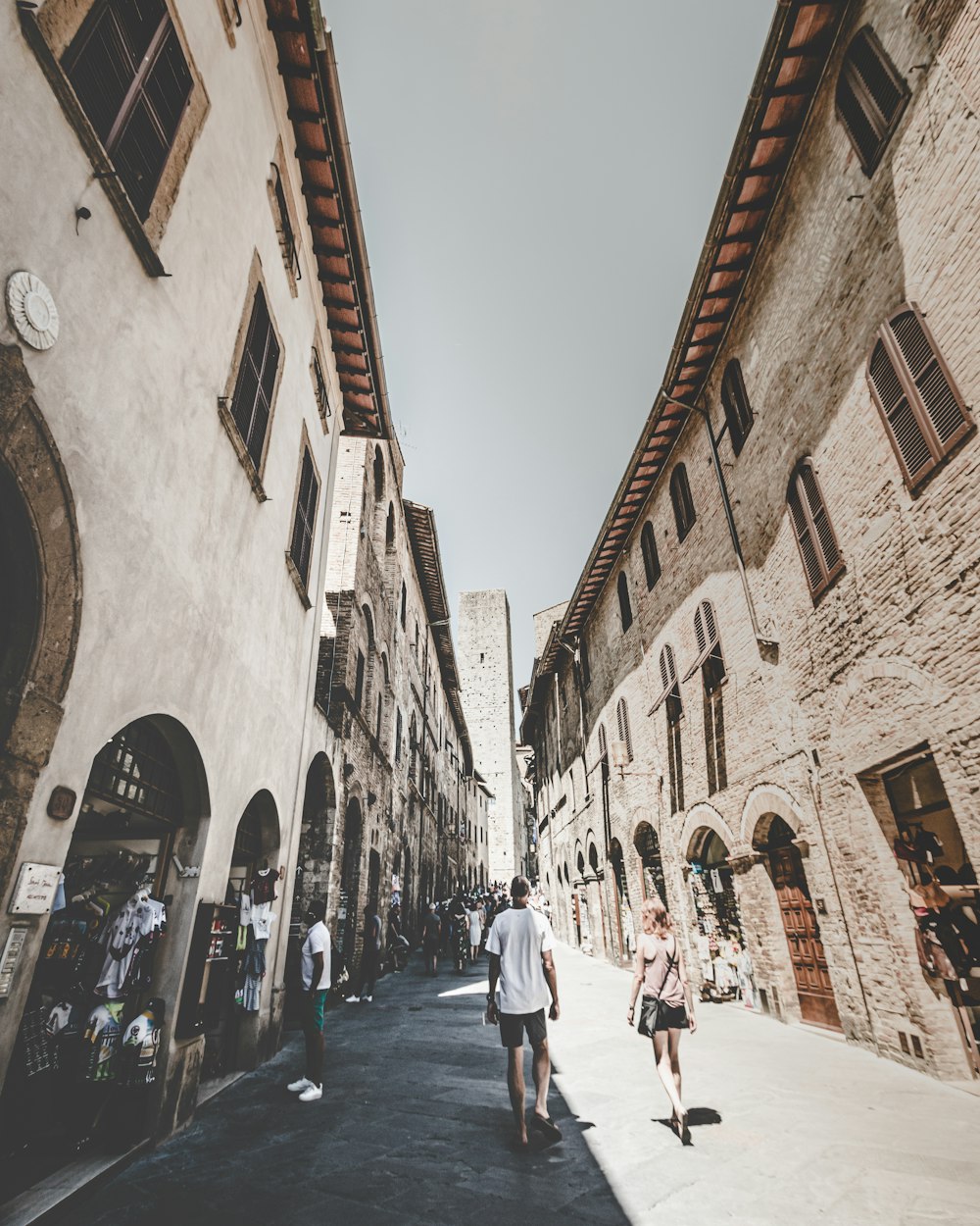 people walking on street between buildings during daytime