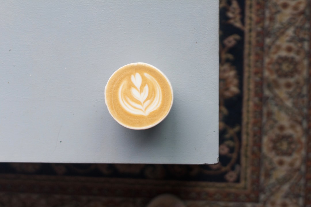 white ceramic mug on white table