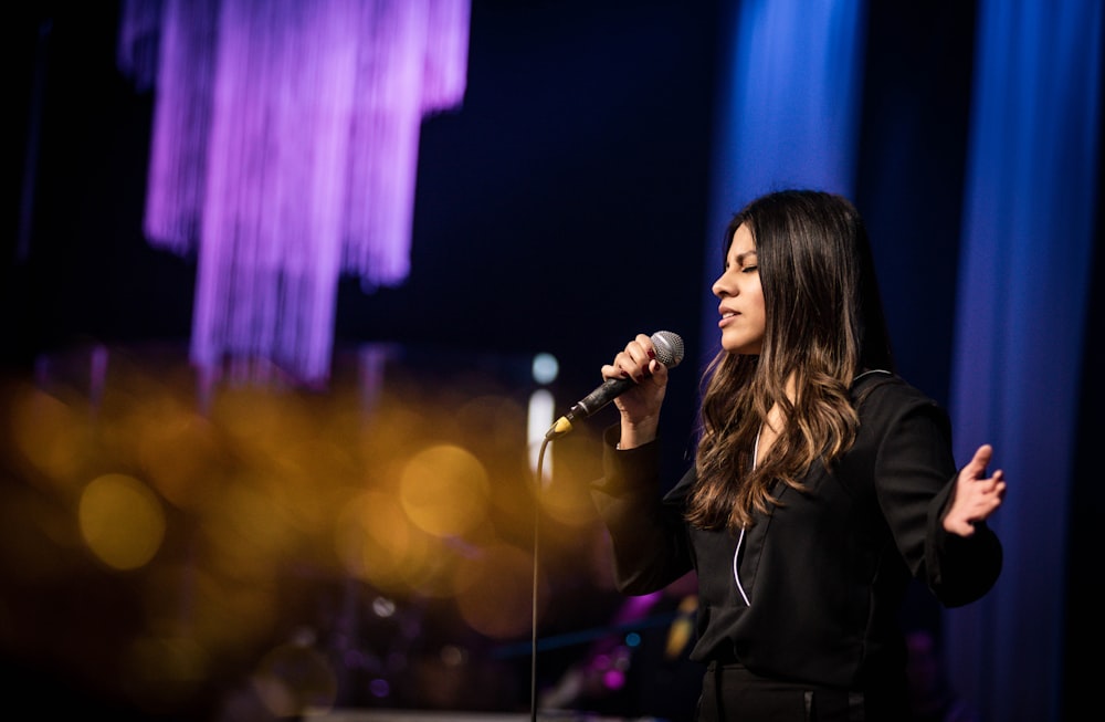 woman in black long sleeve shirt singing