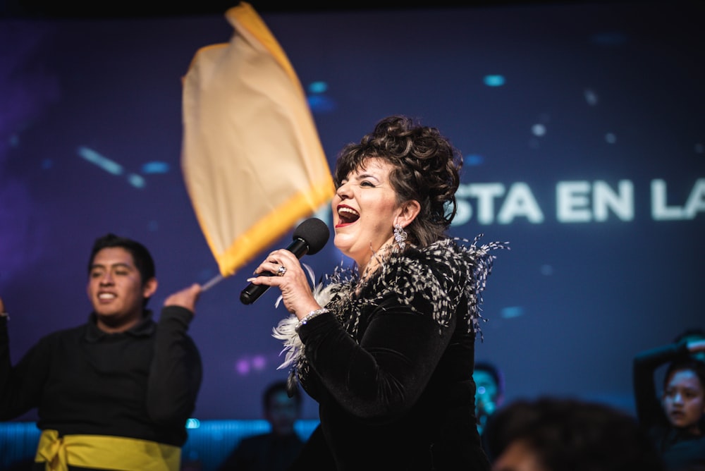 woman in black long sleeve shirt holding microphone