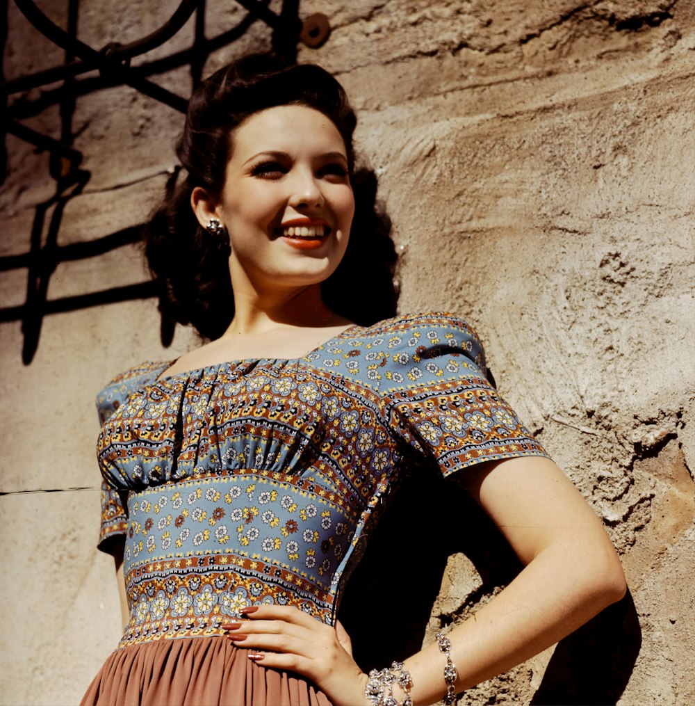 woman in blue and brown floral dress