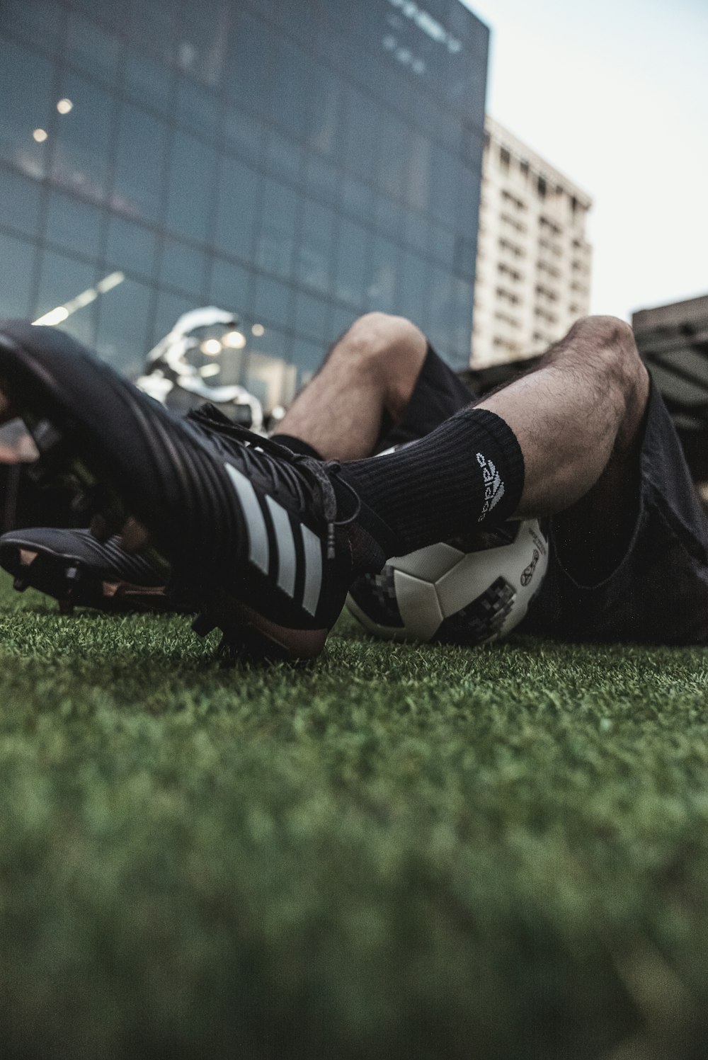 person in black and white adidas sneakers