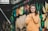 woman in brown coat standing near graffiti wall during daytime