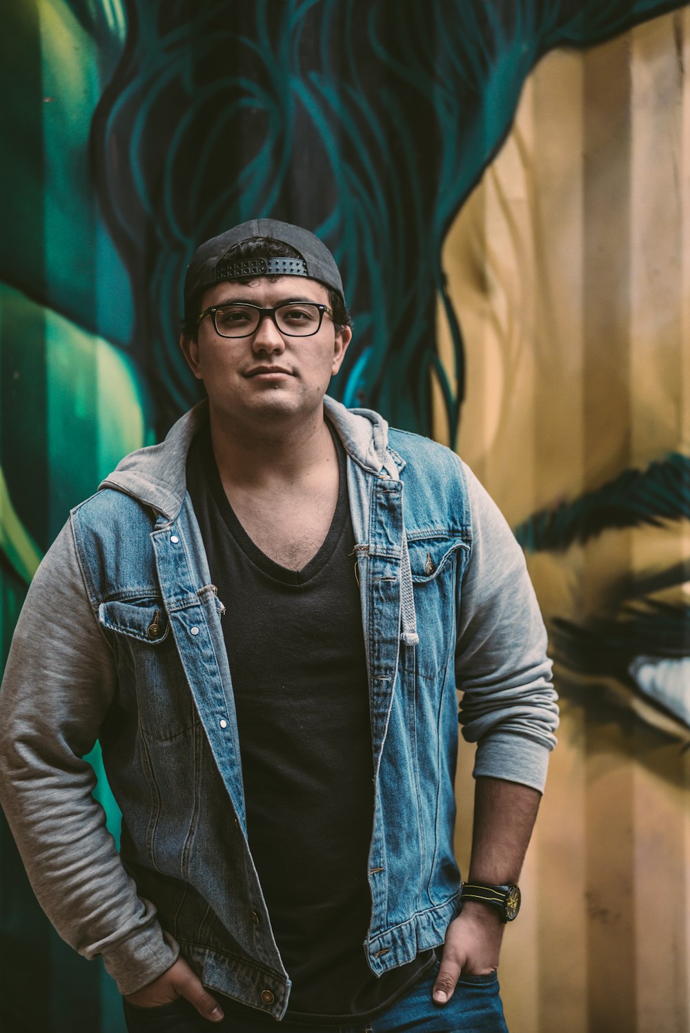 man in blue denim vest and black crew neck shirt