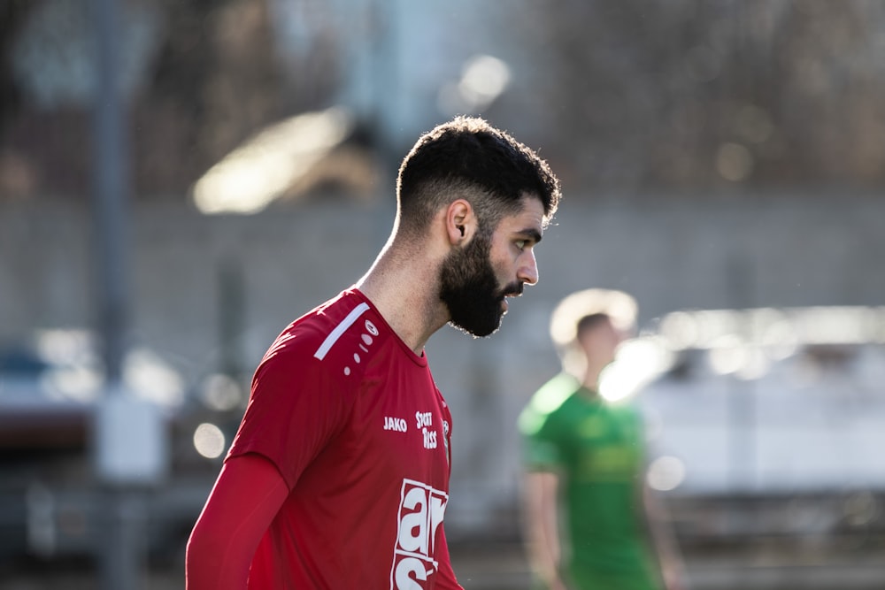 man in red and white nike soccer jersey