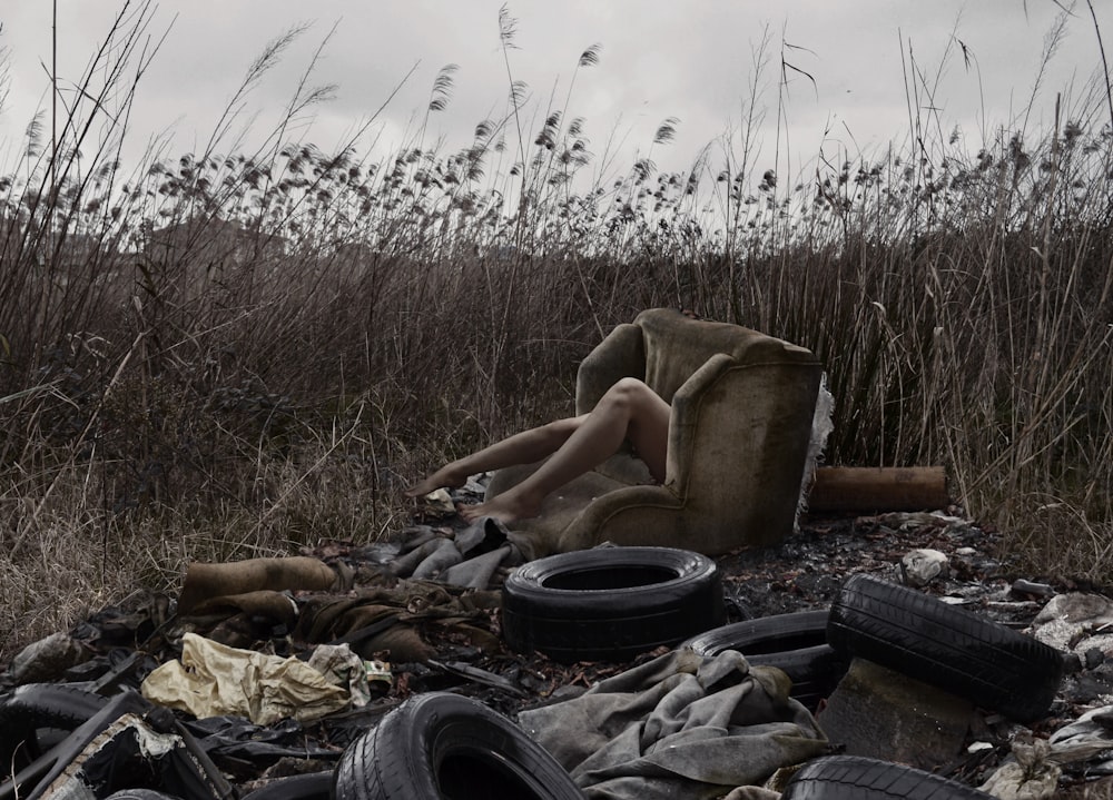 person sitting on black car tire