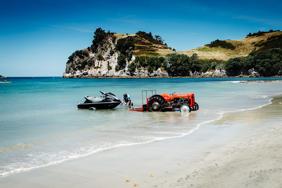 red and black car on beach during daytime