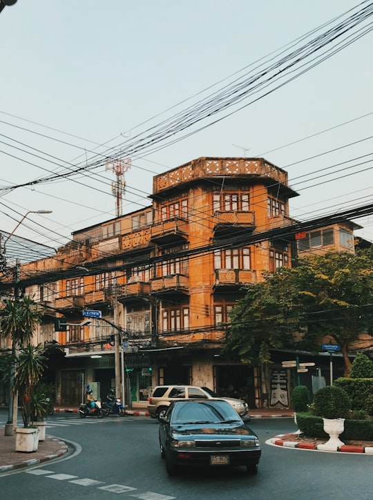 cars parked in front of brown building during daytime in Charoen Krung Thailand