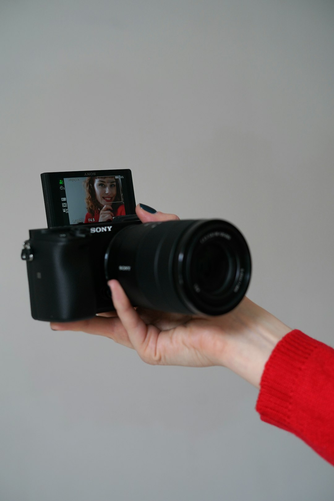 person holding black nikon dslr camera