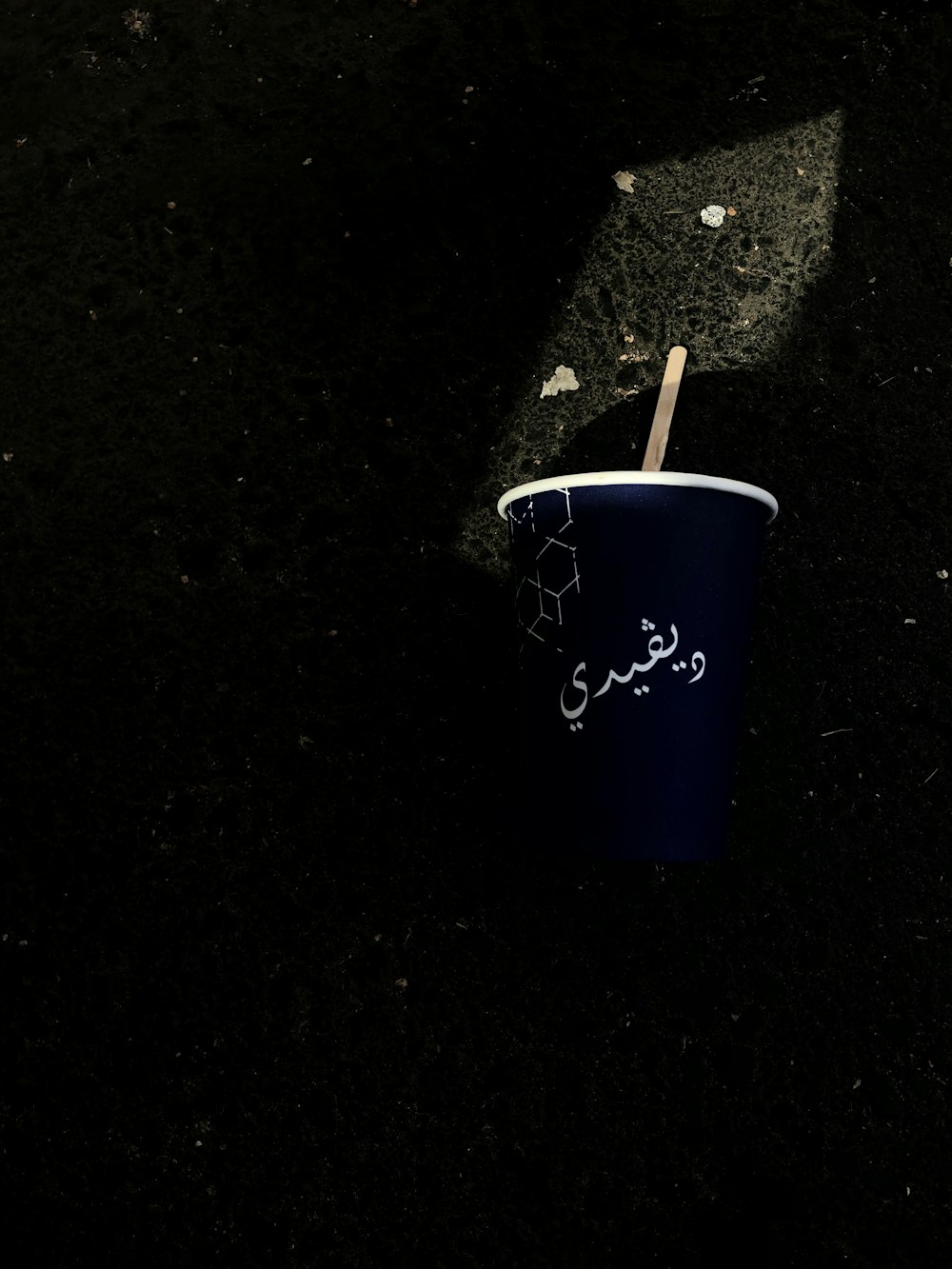 blue and white ceramic mug with white and brown cigarette stick