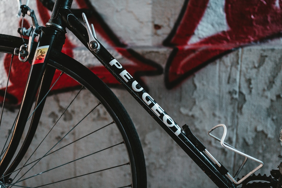 black and red bicycle near white and red wall