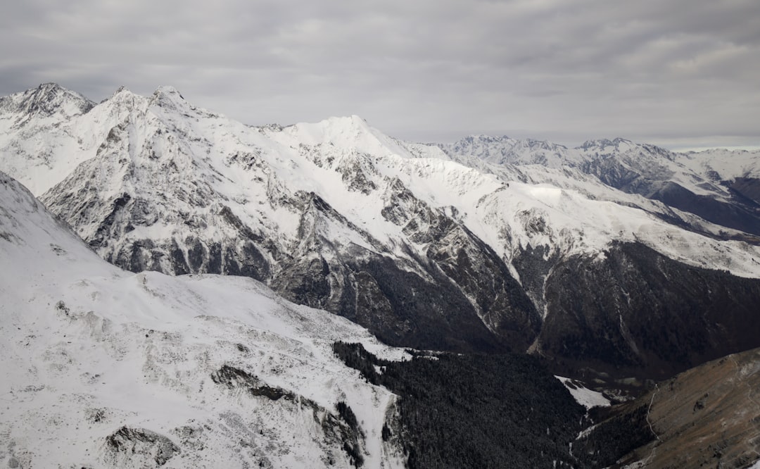 snow covered mountain under cloudy sky during daytime