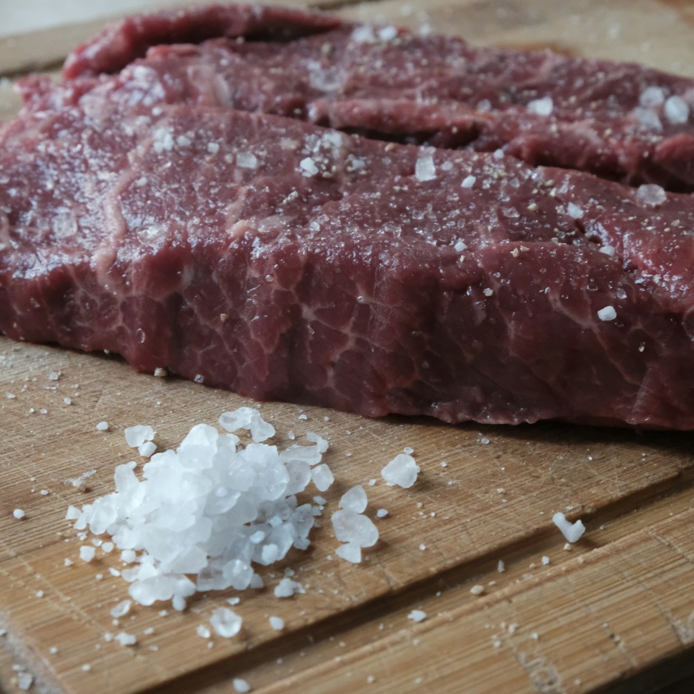 raw meat on brown wooden chopping board