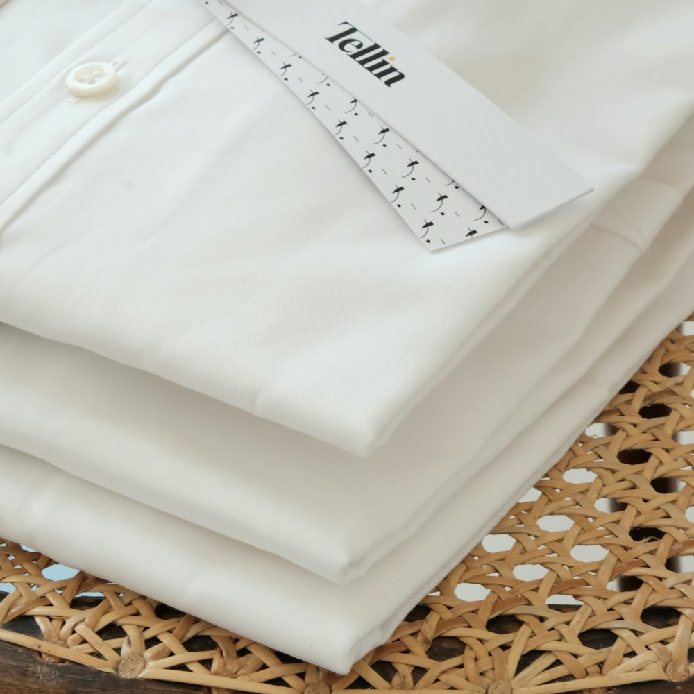 white button up shirt on white textile