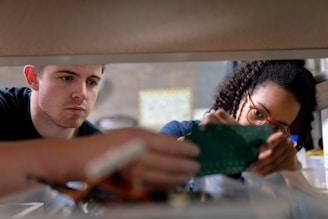 boy in blue crew neck t-shirt holding green textile