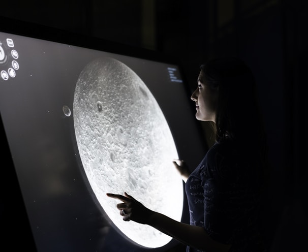 woman in blue dress holding white round board