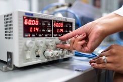 person holding gray audio mixer