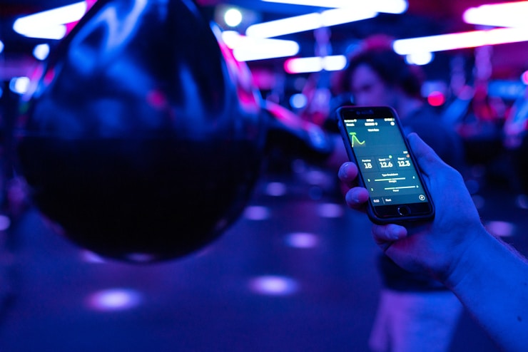 Male engineer monitors boxing performance through athletic devices