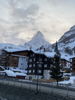 Thumbnail image of snow-capped mountains and a quaint village in Switzerland.