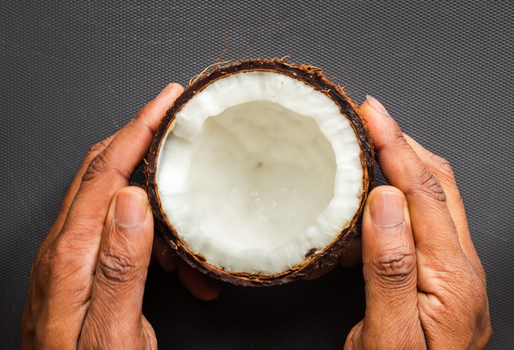 person holding white round cake