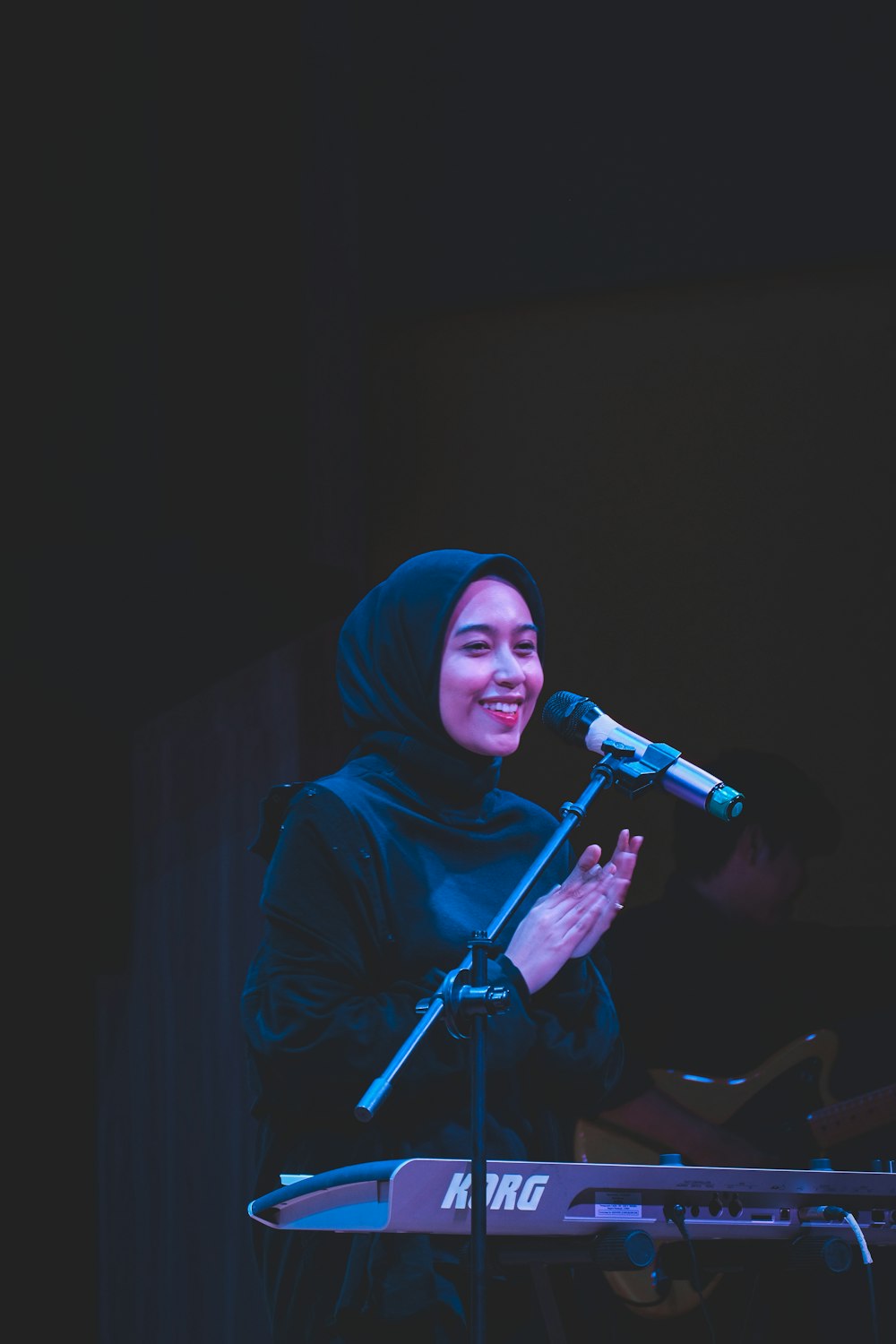 a woman standing in front of a microphone