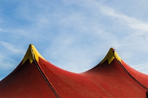 red and yellow umbrella under blue sky