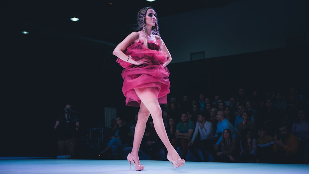 woman in pink dress dancing on stage