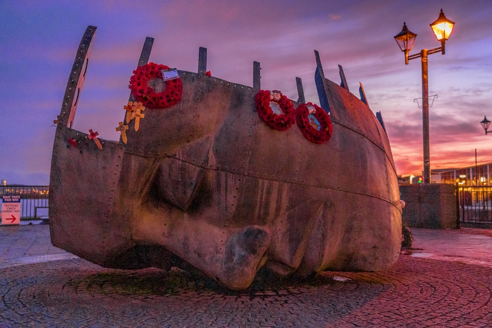 brown ship on sea shore during sunset