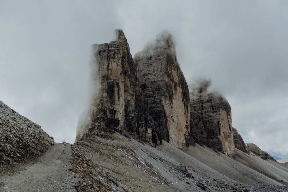 brown rocky mountain under white clouds during daytime