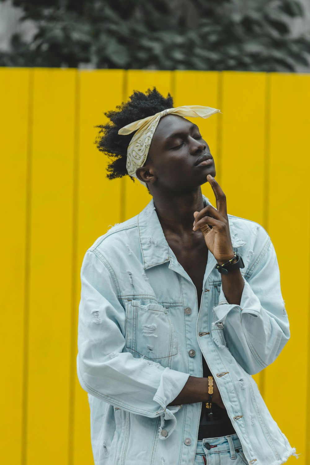 man in white button up shirt wearing white and yellow floral headdress