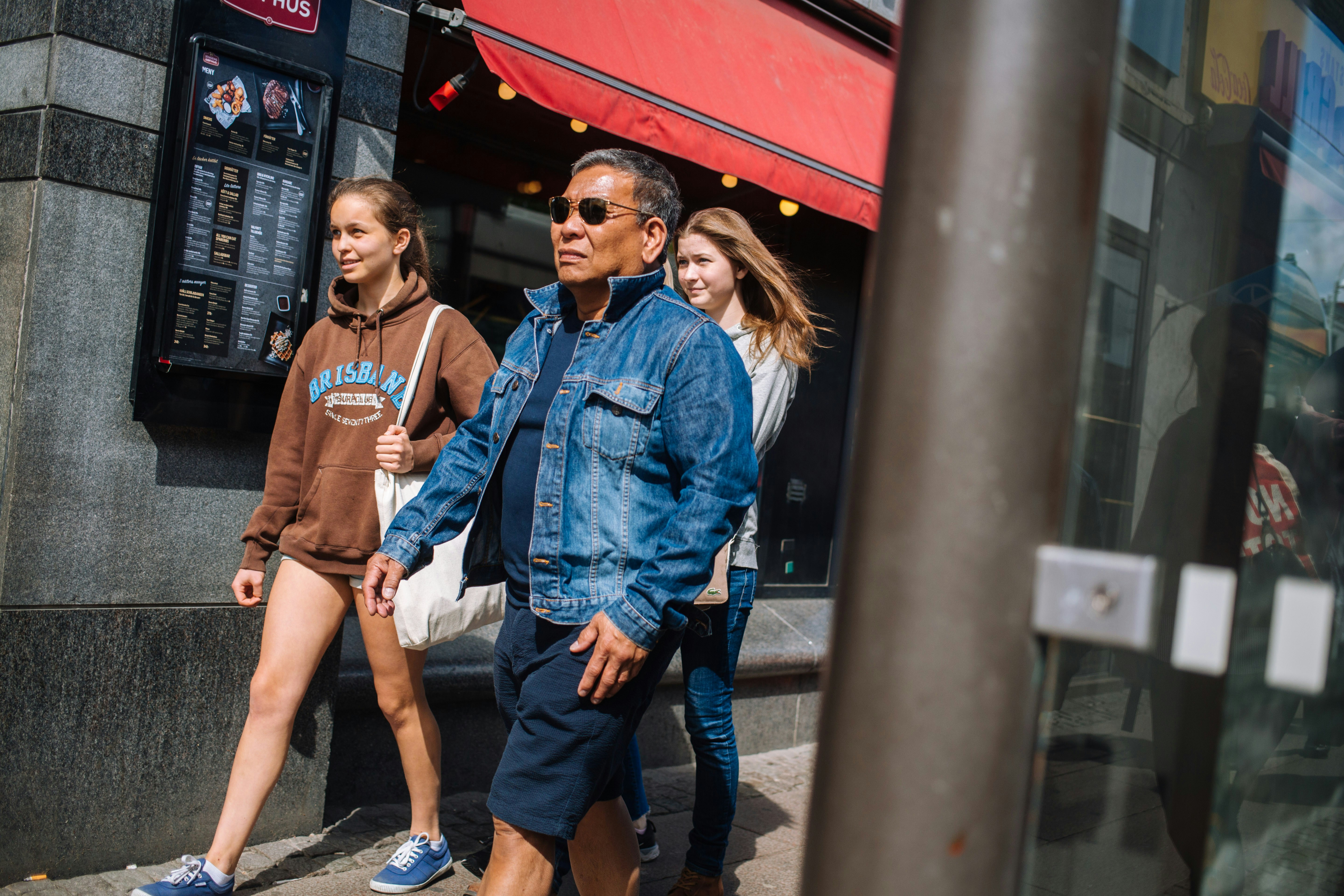 man in blue denim jacket standing beside woman in brown crew neck t-shirt
