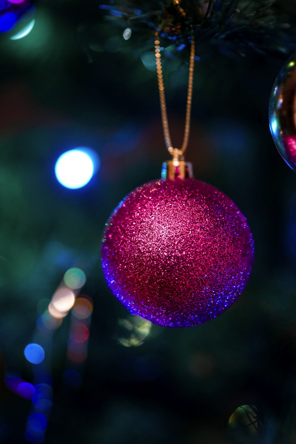 red and gold bauble with bokeh lights