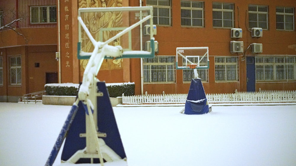 blue and white umbrella on white snow covered ground