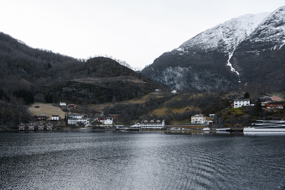 body of water near mountain during daytime