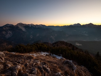 A picturesque mountain landscape during sunset.
